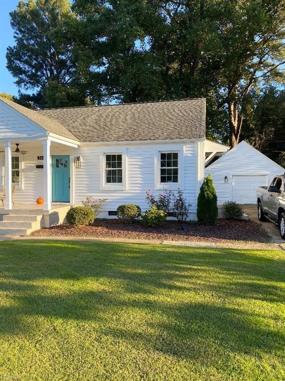 view of front of home with an outdoor structure, a front lawn, a porch, and a garage