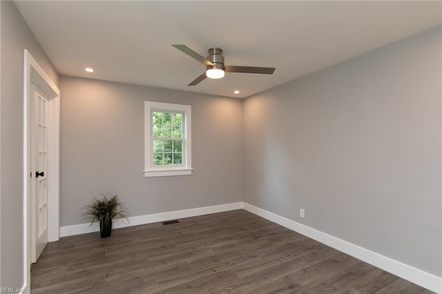 empty room with ceiling fan and dark hardwood / wood-style floors