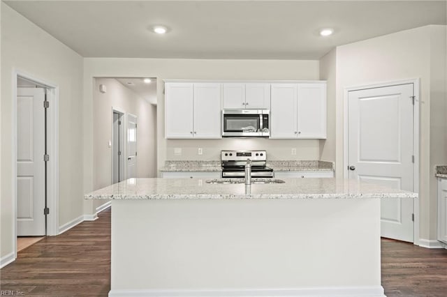 kitchen with a center island with sink, dark wood-type flooring, white cabinets, and stainless steel appliances