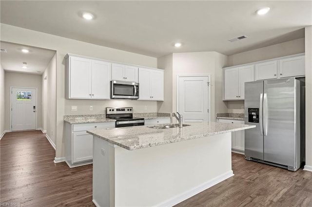 kitchen featuring appliances with stainless steel finishes, white cabinets, a kitchen island with sink, and dark wood-type flooring