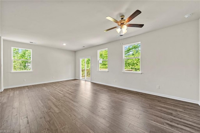 unfurnished room with ceiling fan and dark hardwood / wood-style floors