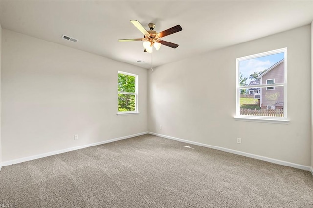 spare room featuring ceiling fan and carpet floors