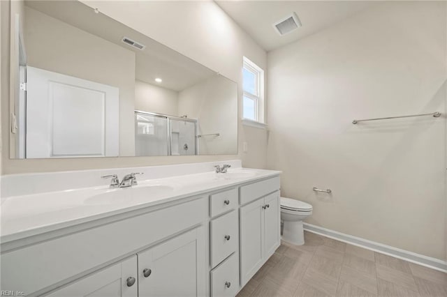 bathroom featuring toilet, an enclosed shower, and vanity