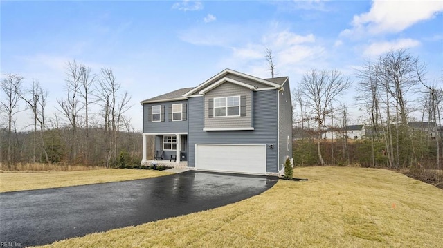 view of front of property featuring a front lawn and a garage