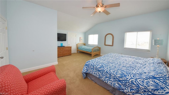 bedroom featuring multiple windows, light colored carpet, vaulted ceiling, and ceiling fan