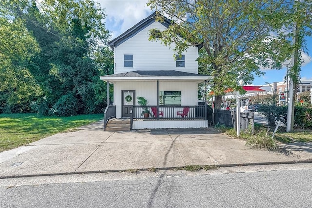 view of front of house with covered porch and a front yard