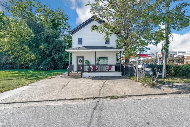 view of front of house featuring covered porch and a front yard