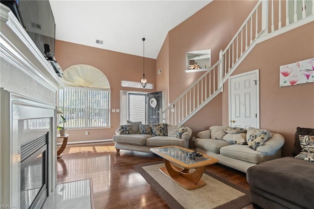 living room with dark hardwood / wood-style floors and high vaulted ceiling