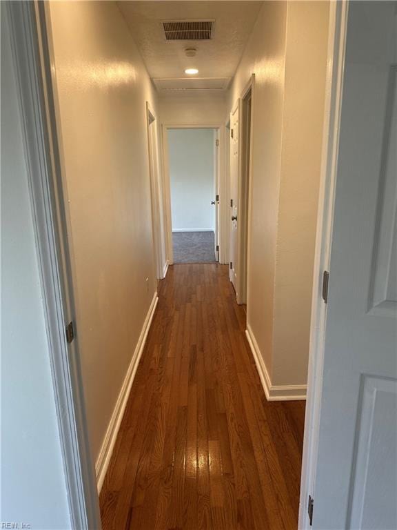 corridor with dark hardwood / wood-style floors