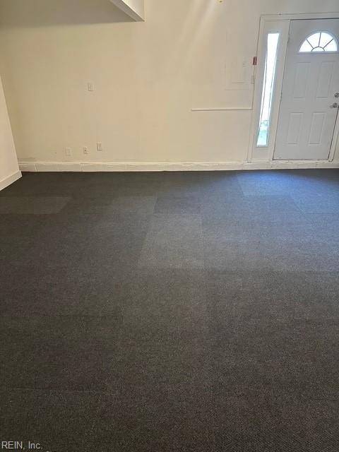 entryway featuring dark colored carpet