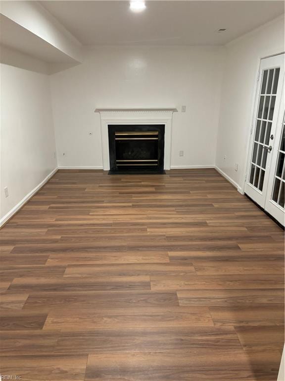 unfurnished living room featuring dark hardwood / wood-style floors