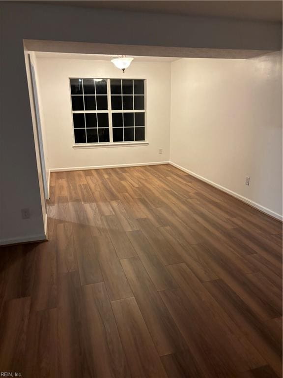 unfurnished room featuring dark hardwood / wood-style flooring