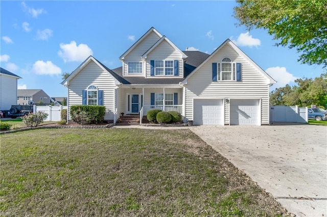 view of front of house featuring a front yard, covered porch, and a garage