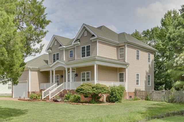 view of front of property featuring a front yard, covered porch, and a garage