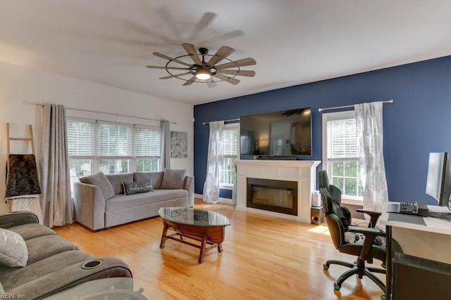 living room with light wood-type flooring and ceiling fan