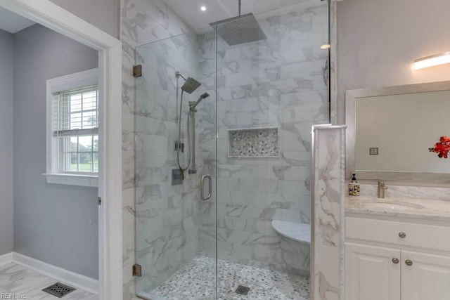 bathroom with vanity and a shower with door