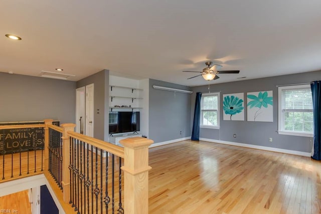 living room with ceiling fan and hardwood / wood-style floors