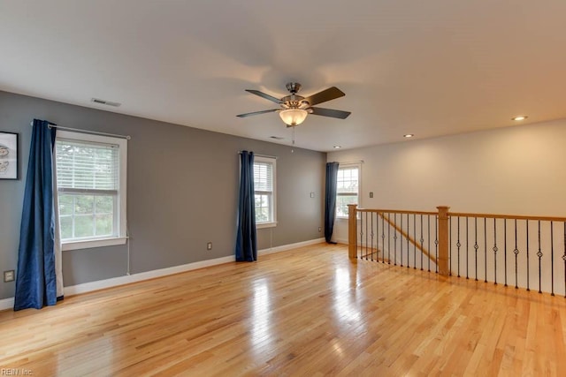 unfurnished room with light wood-type flooring and ceiling fan