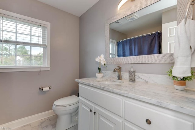 bathroom featuring vanity and toilet