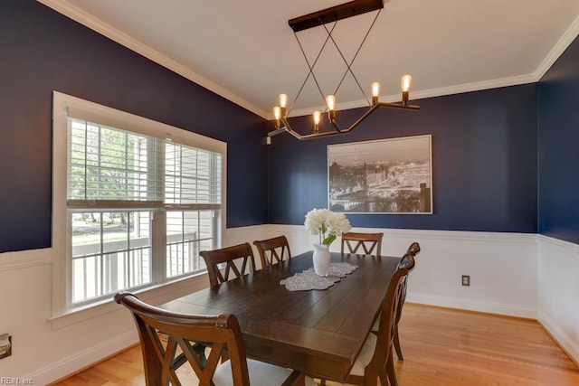 dining area with crown molding, wood-type flooring, and a wealth of natural light