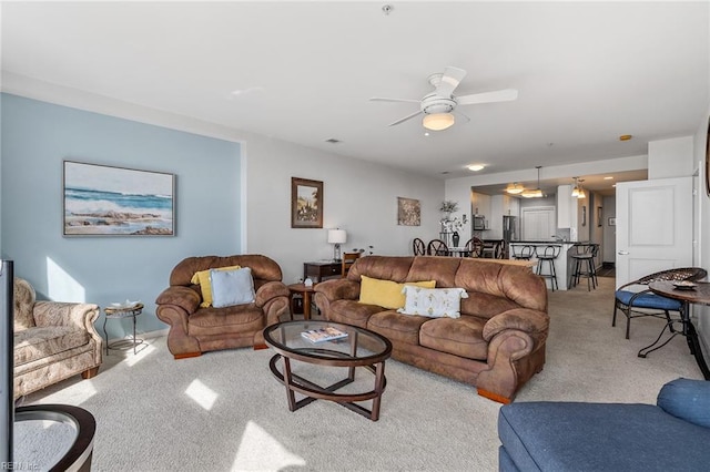 carpeted living room featuring ceiling fan