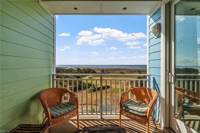 balcony featuring a water view