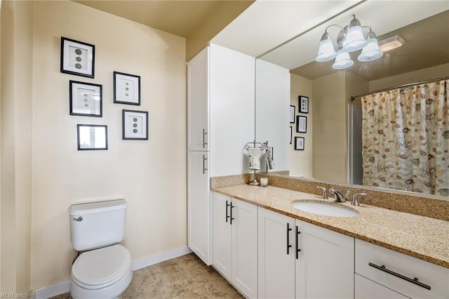 bathroom featuring an inviting chandelier, vanity, toilet, and tile patterned floors