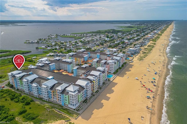 birds eye view of property featuring a water view and a beach view