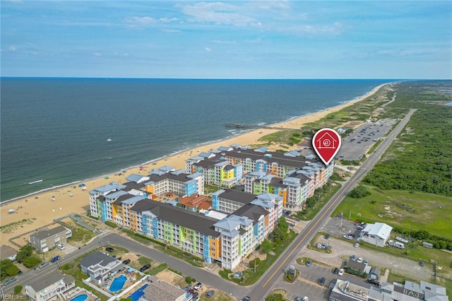 birds eye view of property featuring a water view and a beach view