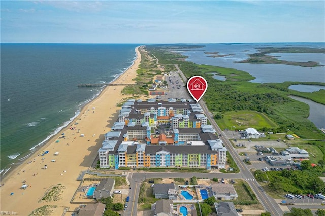 drone / aerial view with a water view and a beach view