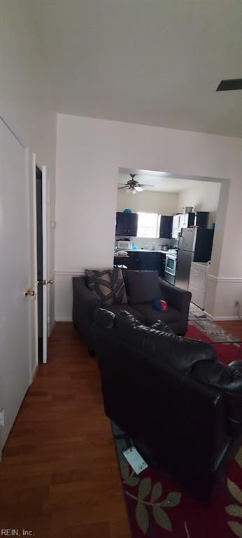 living room with ceiling fan and dark hardwood / wood-style floors