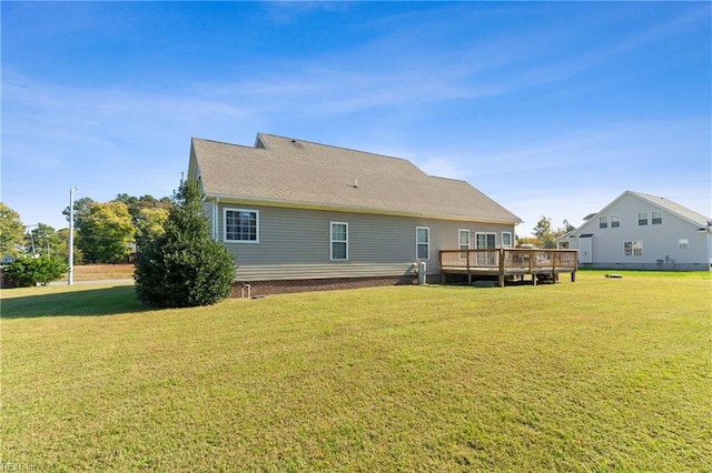 back of house with a wooden deck and a yard