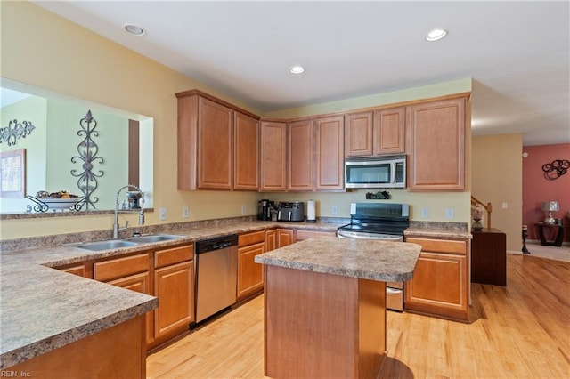 kitchen featuring a center island, sink, appliances with stainless steel finishes, and light hardwood / wood-style floors