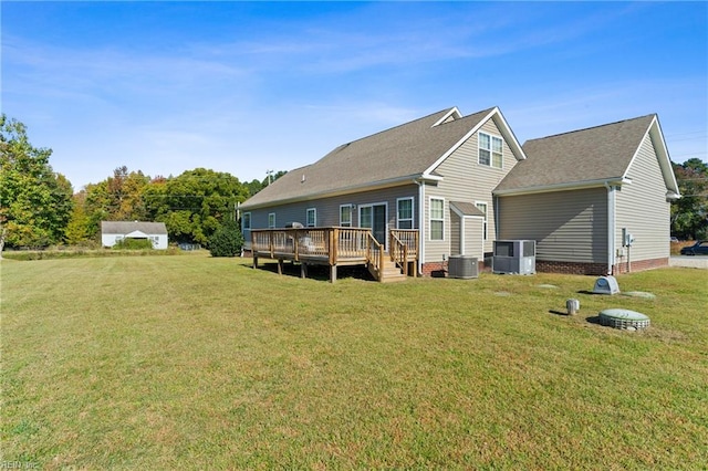 back of property featuring a yard, a deck, and central air condition unit