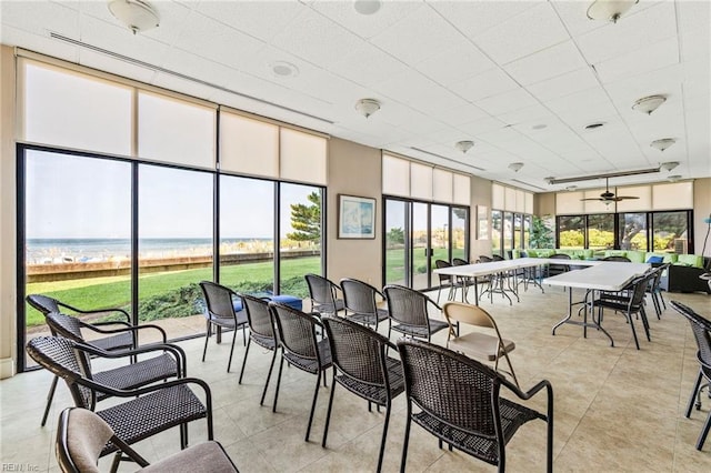 sunroom featuring ceiling fan