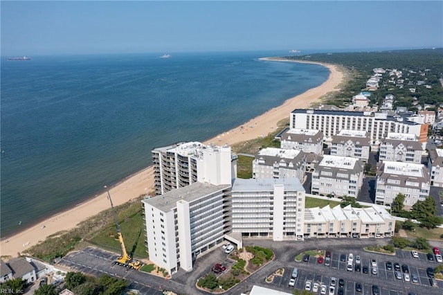 birds eye view of property with a water view and a beach view