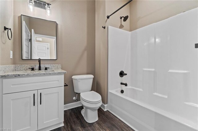 full bathroom featuring vanity, tub / shower combination, wood-type flooring, and toilet