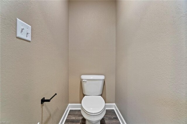 bathroom featuring toilet and hardwood / wood-style flooring