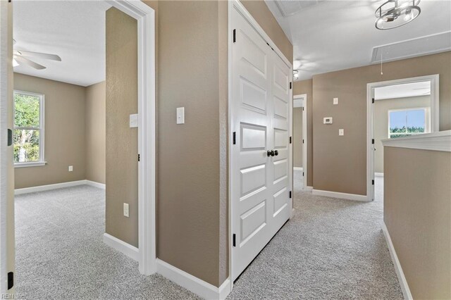 hallway featuring light carpet