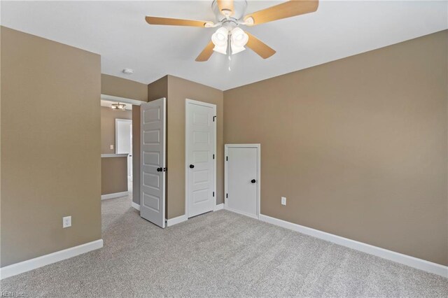 unfurnished bedroom featuring ceiling fan and light carpet