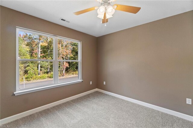 empty room with carpet flooring and ceiling fan