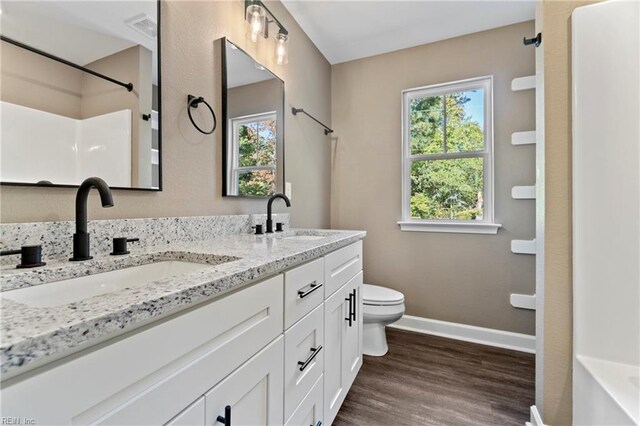 full bathroom featuring bathtub / shower combination, vanity, wood-type flooring, and toilet