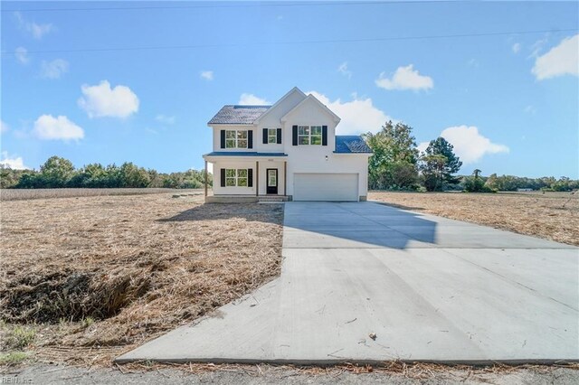 view of front of house featuring a rural view and a garage