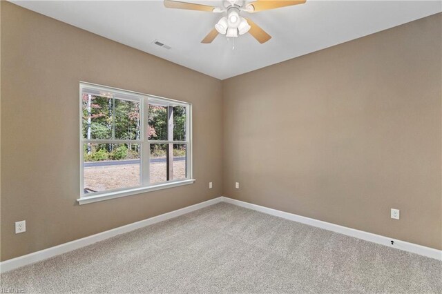 spare room featuring carpet floors and ceiling fan