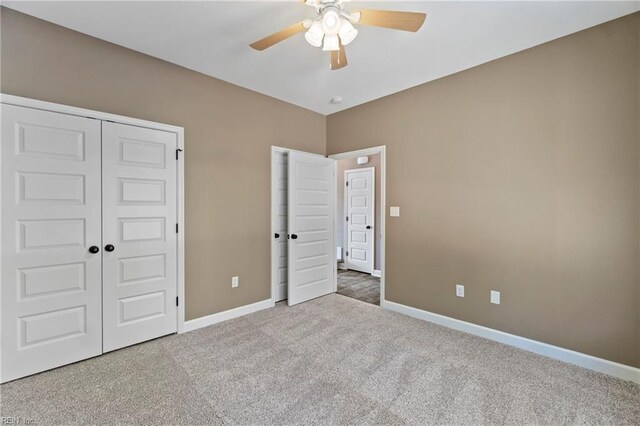 unfurnished bedroom with a closet, ceiling fan, and carpet flooring