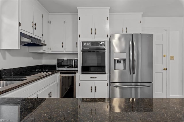 kitchen with dark stone countertops, beverage cooler, black appliances, and white cabinets