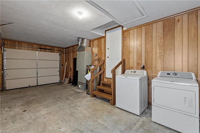 washroom featuring washer and clothes dryer and wooden walls