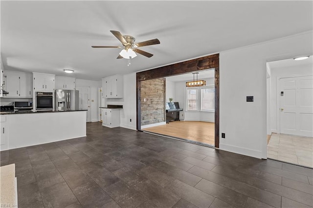 unfurnished living room with ceiling fan and dark hardwood / wood-style flooring