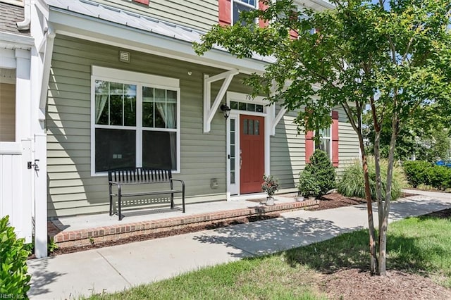 view of exterior entry with a porch