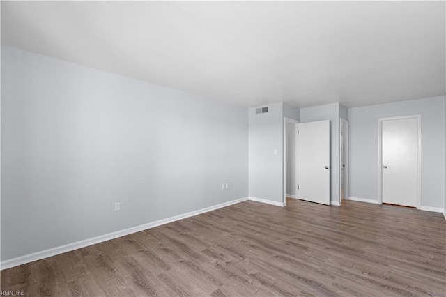 spare room with hardwood / wood-style floors